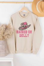 RAISED ON DOLLY GRAPHIC SWEATSHIRT