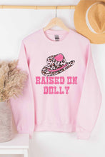 RAISED ON DOLLY GRAPHIC SWEATSHIRT